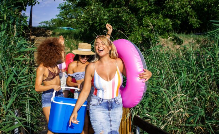 A group of female friends enjoying the summer with an ice chest and pool rings